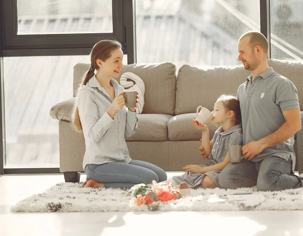 Family relaxing in their living room after pest treatment