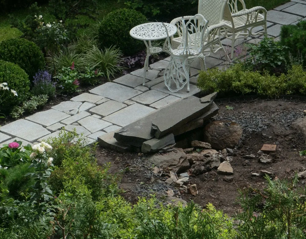 Outdoor furniture on a paved garden path where spiders like to settle
