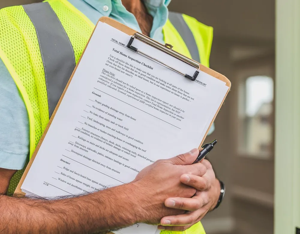 Inspector holding a checklist during a property visit