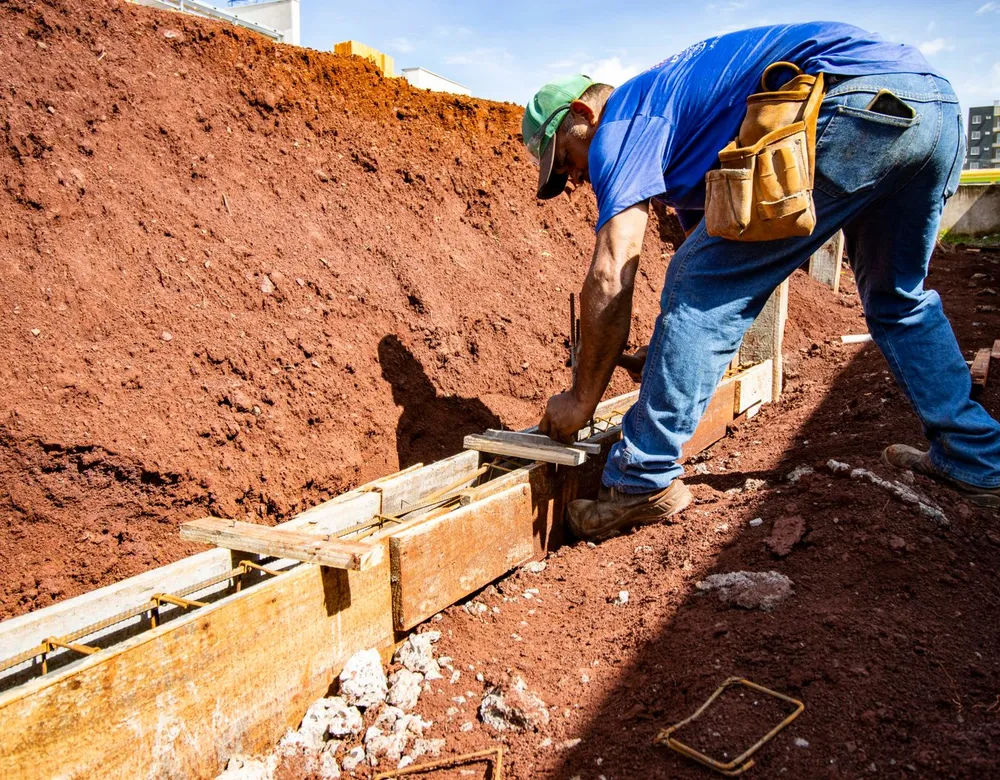 Workers preparing a home foundation, where termite barriers are installed